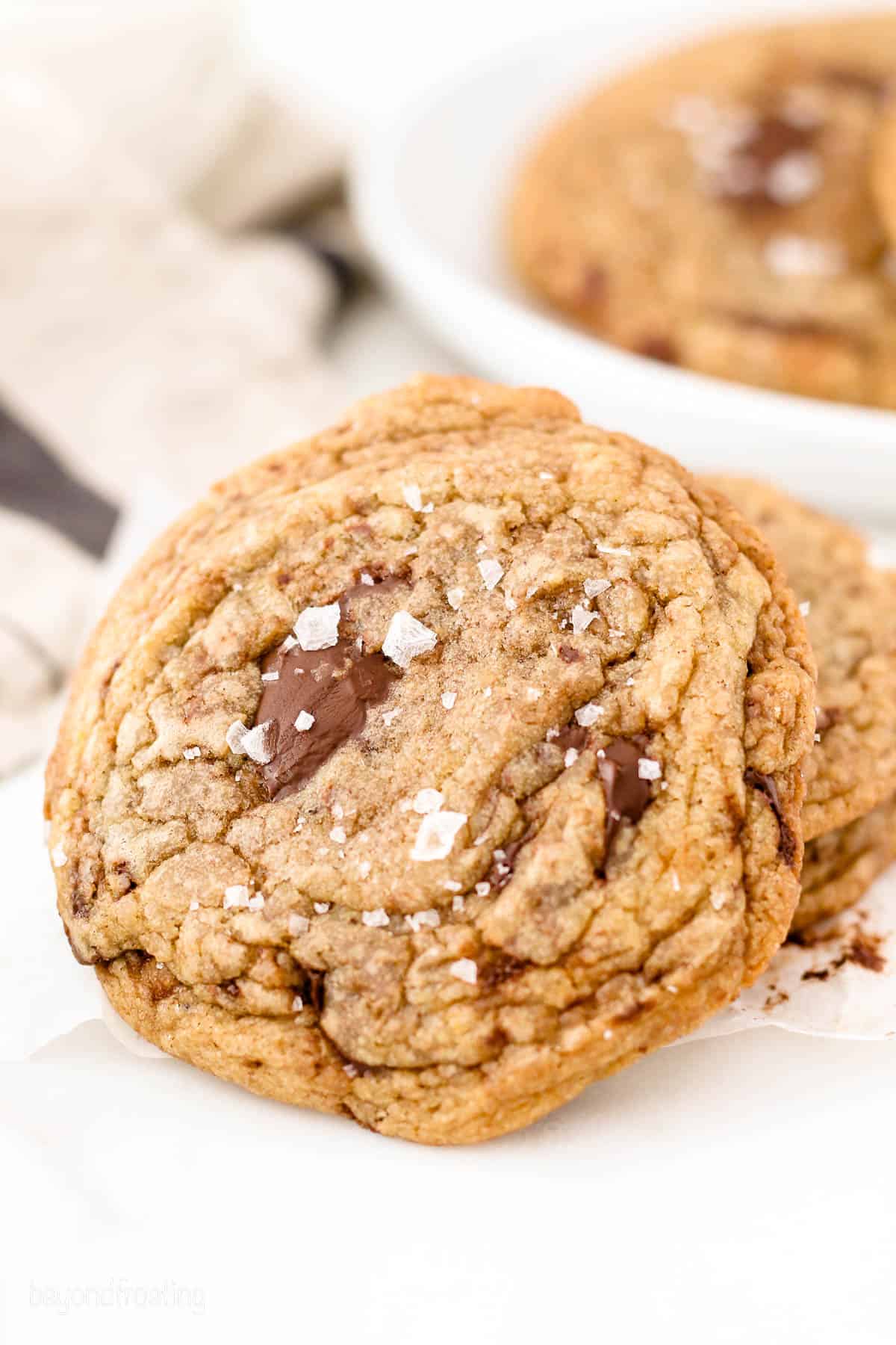 a chocolate chip cookie leaning on two other cookies