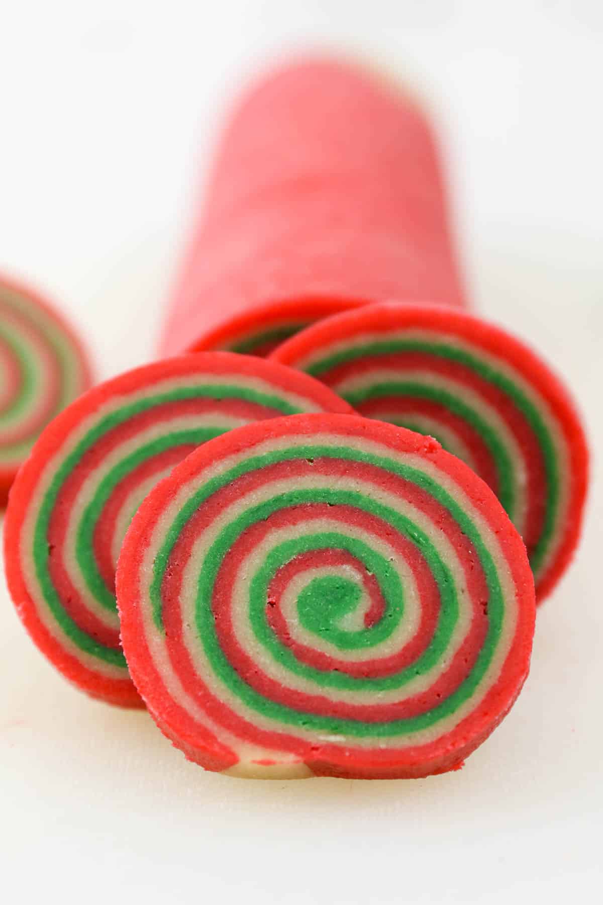Front view of pinwheel cookies cut from a cookie dough log.