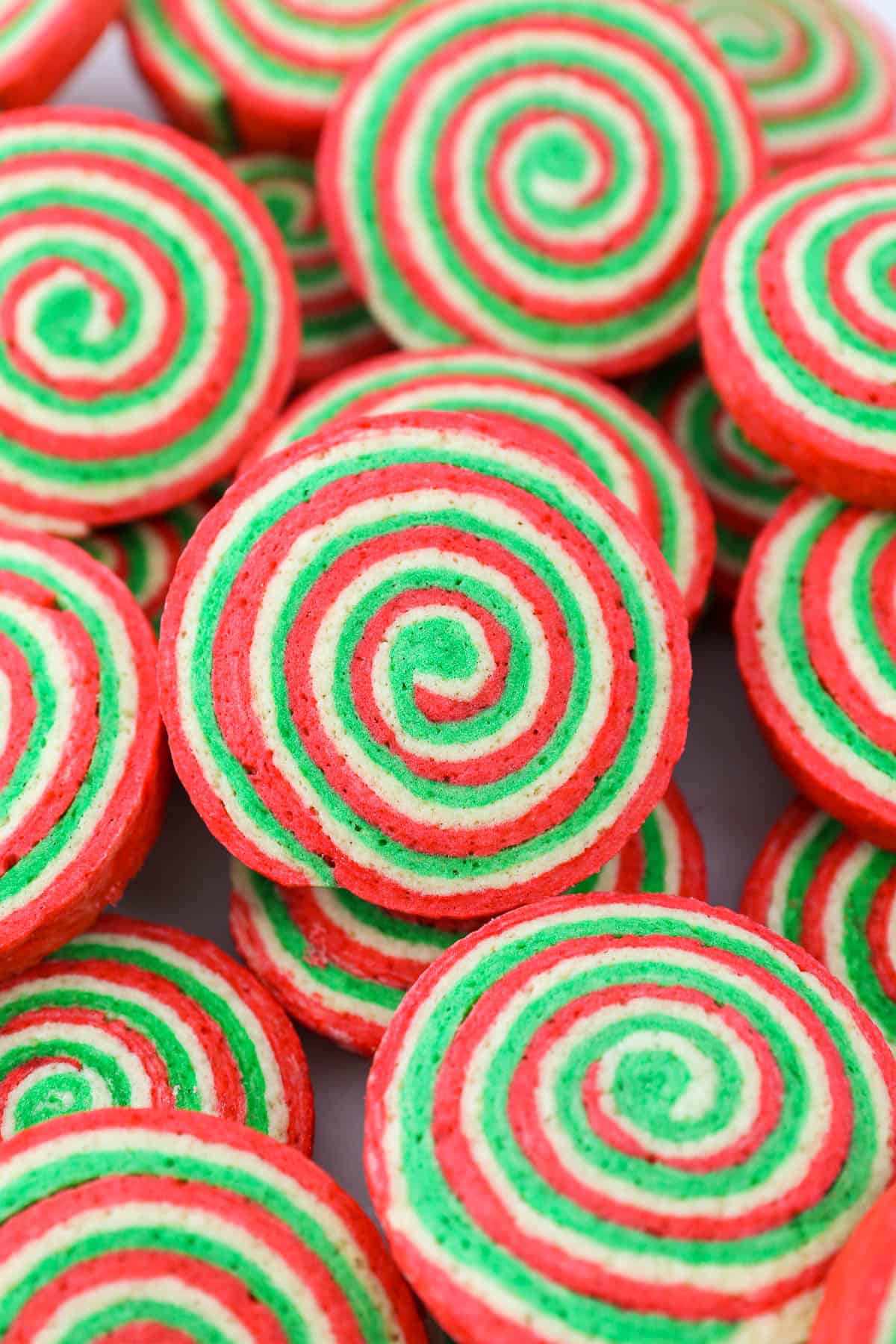 Assorted red and green baked Christmas pinwheel cookies.