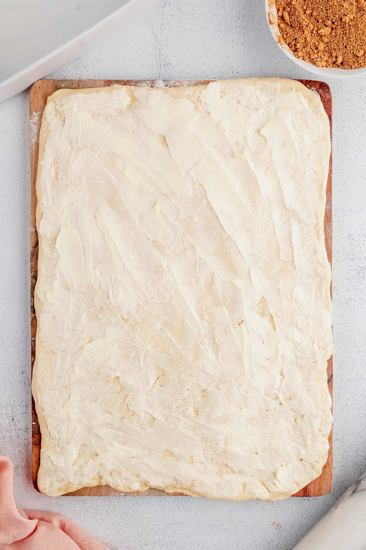 A large dough rectangle covered in butter.