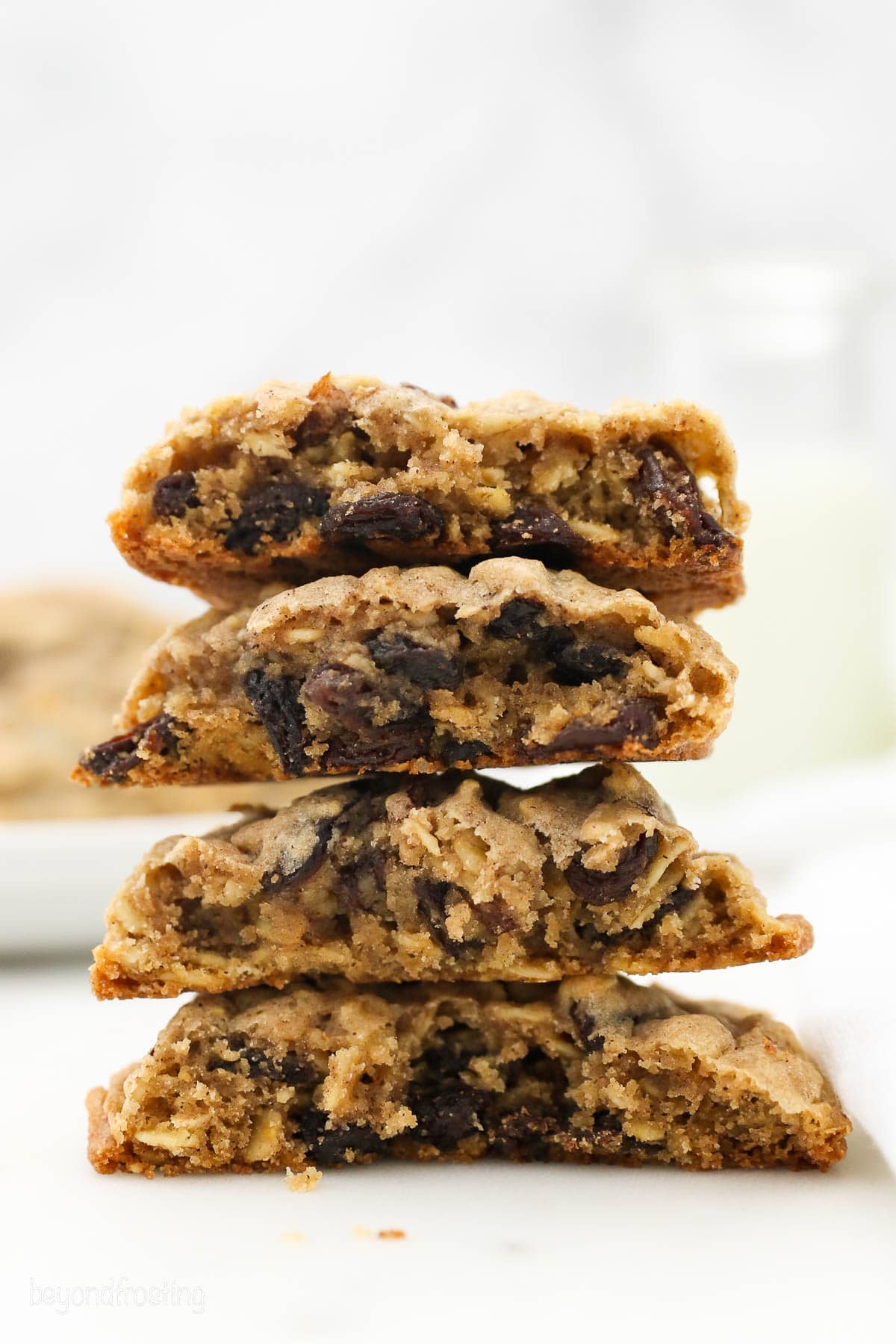 A stack of 4 halves of Oatmeal Raison cookies to show the inside
