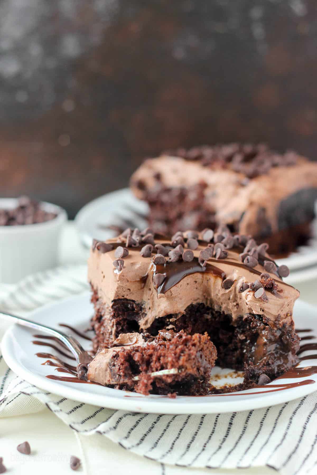 a slice of poke cake with a forkful on a plate