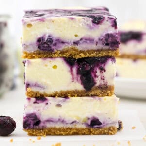 Three blueberry cheesecake bars stacked up