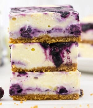 Three blueberry cheesecake bars stacked up
