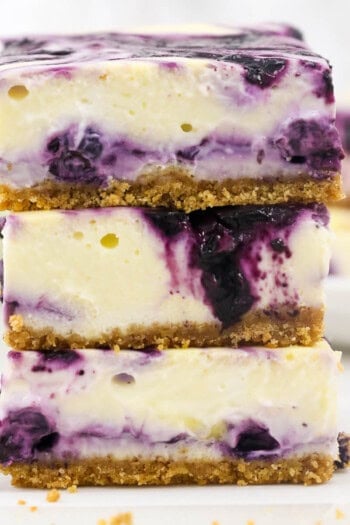 Three blueberry cheesecake bars stacked up