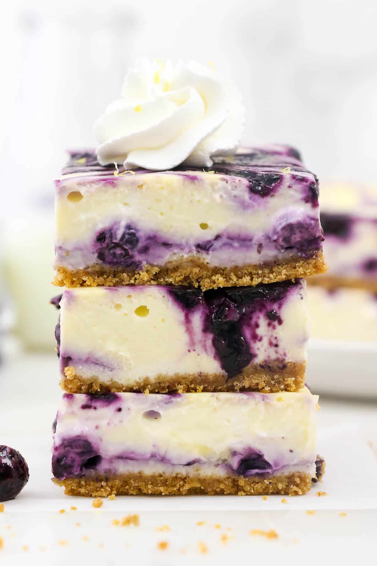 Three blueberry cheesecake bars stacked up