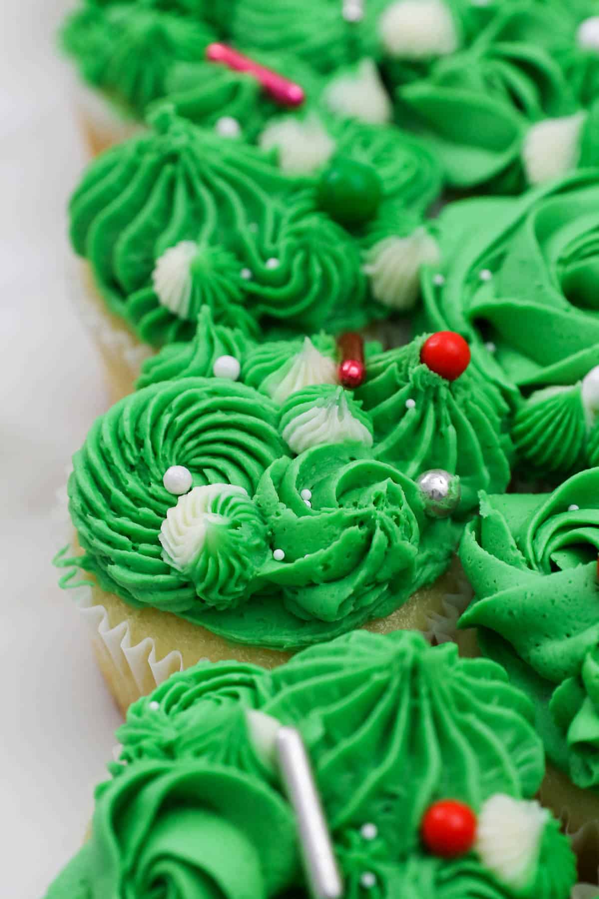 A close-up shot of cupcakes decorated to look like portions of a Christmas tree