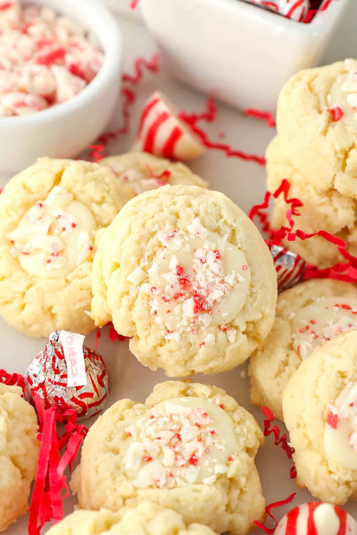 overhead of peppermint cookies stacked with a bowl of peppermint candy
