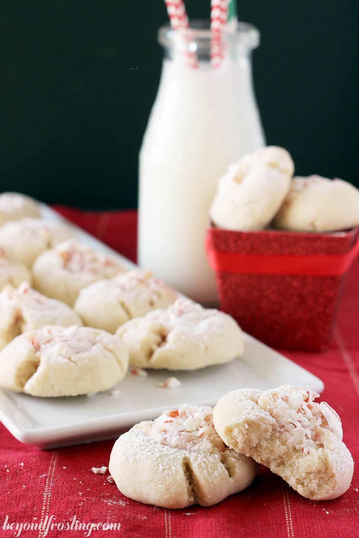 A plate of peppermint thumbprint cookies on a red napkin