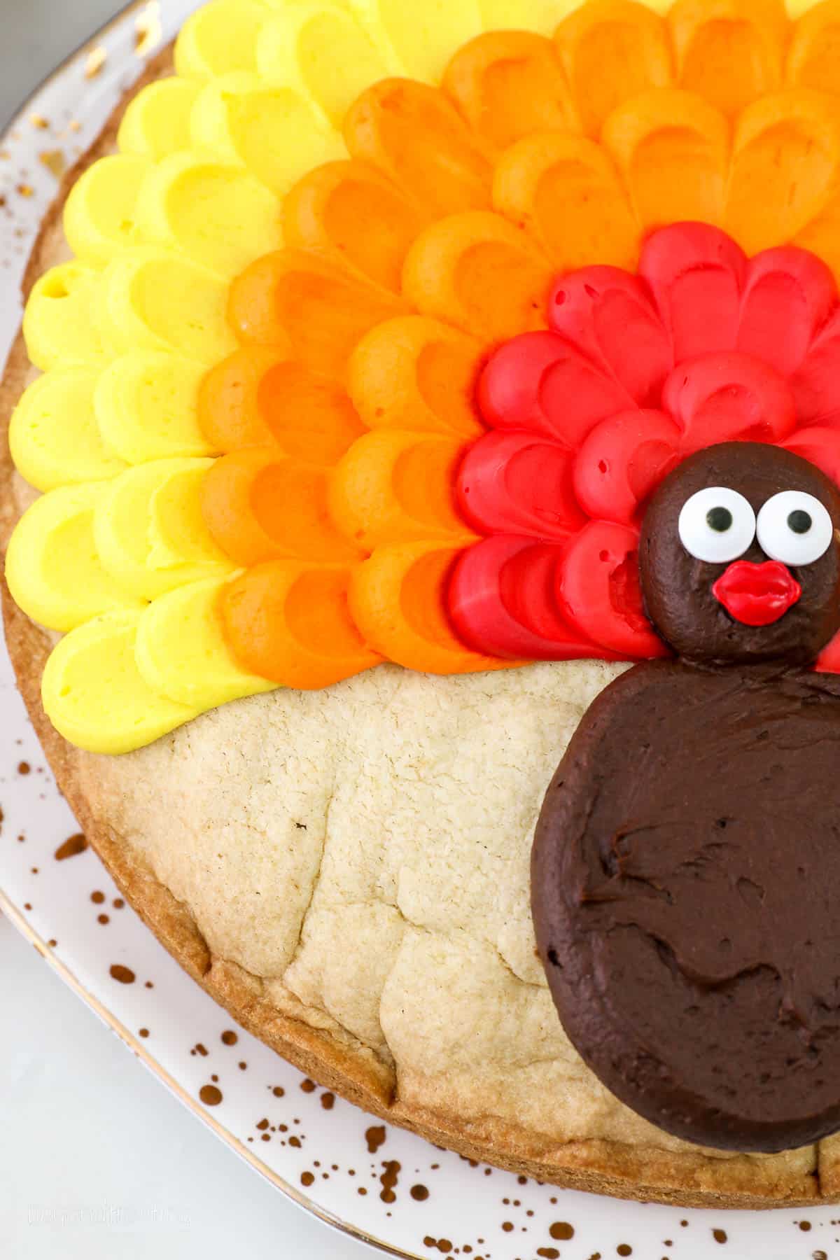 close up of a buttercream turkey on a cookie cake