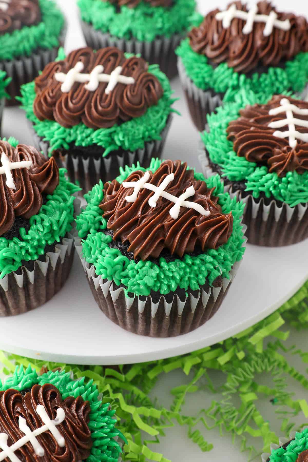 Football cupcakes arranges on a cake stand.