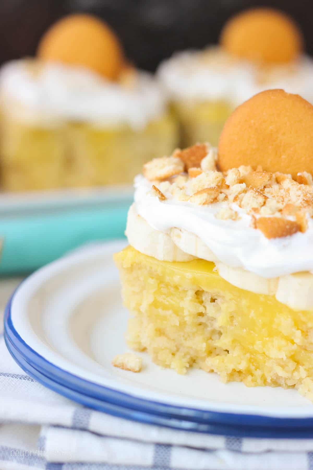 closeup side view of a square slice of banana cake topped with Nilla wafers.