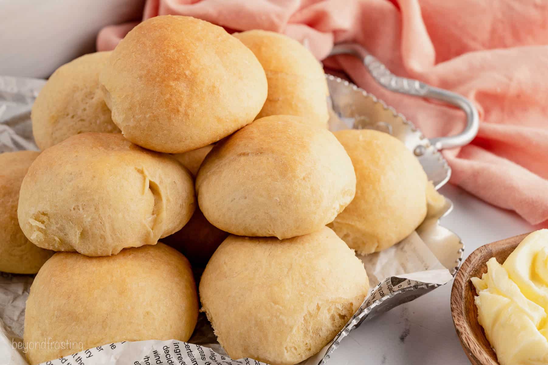 Quick dinner rolls stacked inside a large bowl.