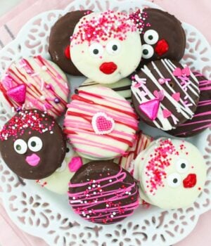 a plate of Chocolate covered Oreos decorated for Valentine's Day on a white plate