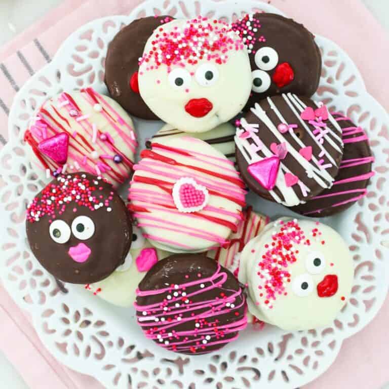 a plate of Chocolate covered Oreos decorated for Valentine's Day on a white plate