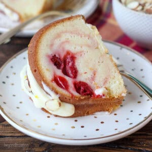 a slice of bundt cake on a white plate with gold flecks.