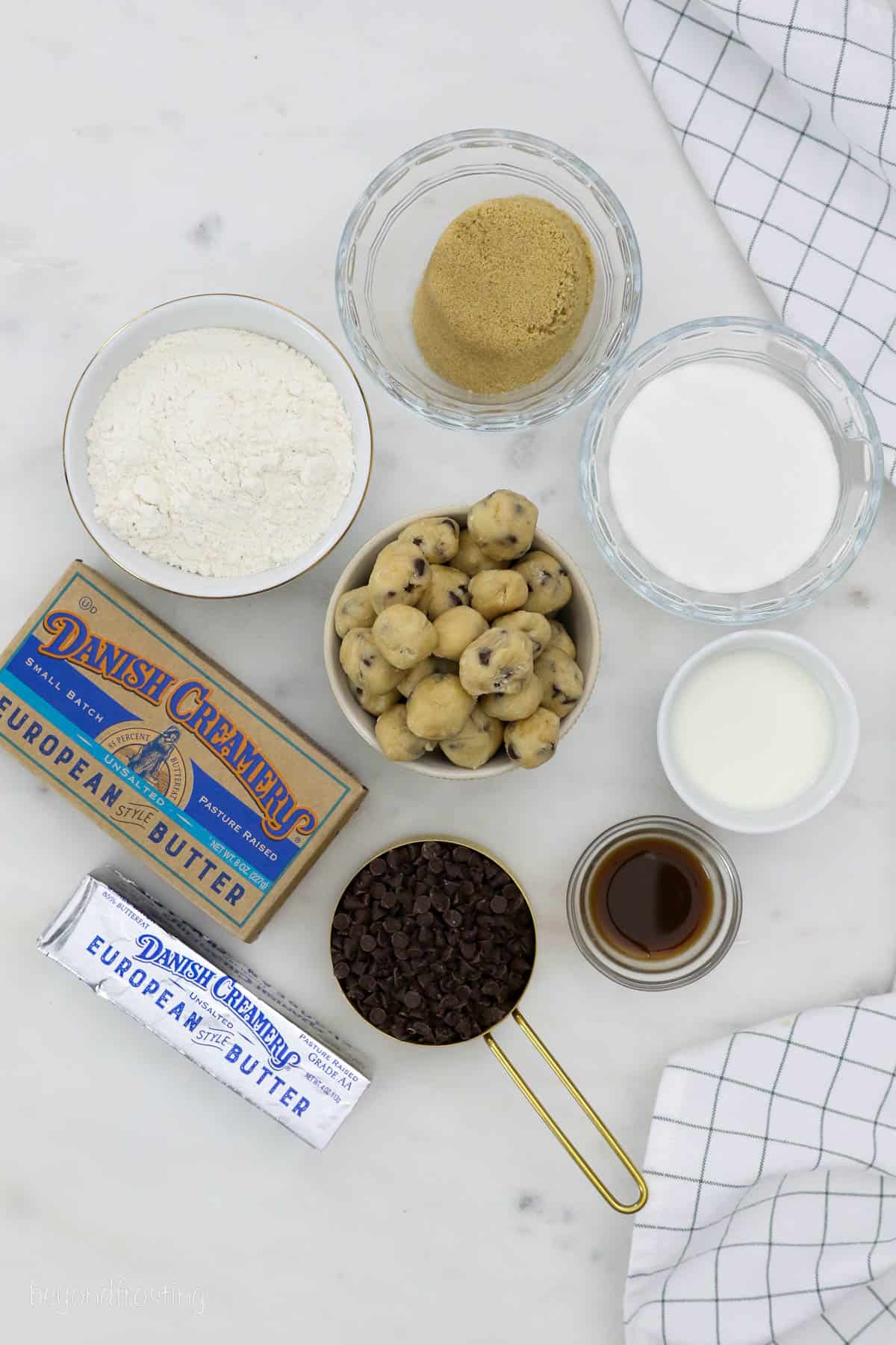 overhead of cookie dough cheesecake ingredients on a counter.