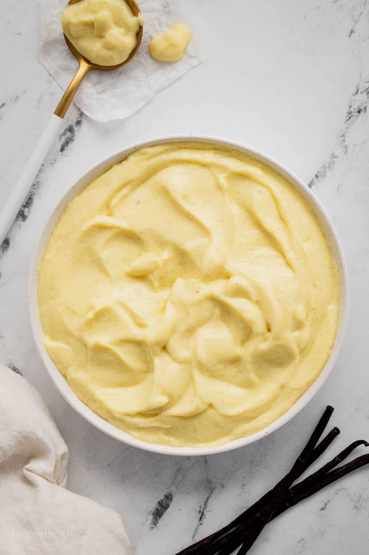 Overhead view of a bowl of vanilla pastry cream.