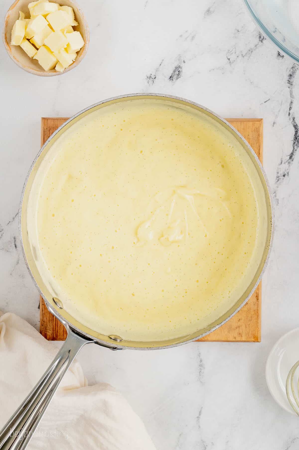 Tempered pastry cream in a saucepan.