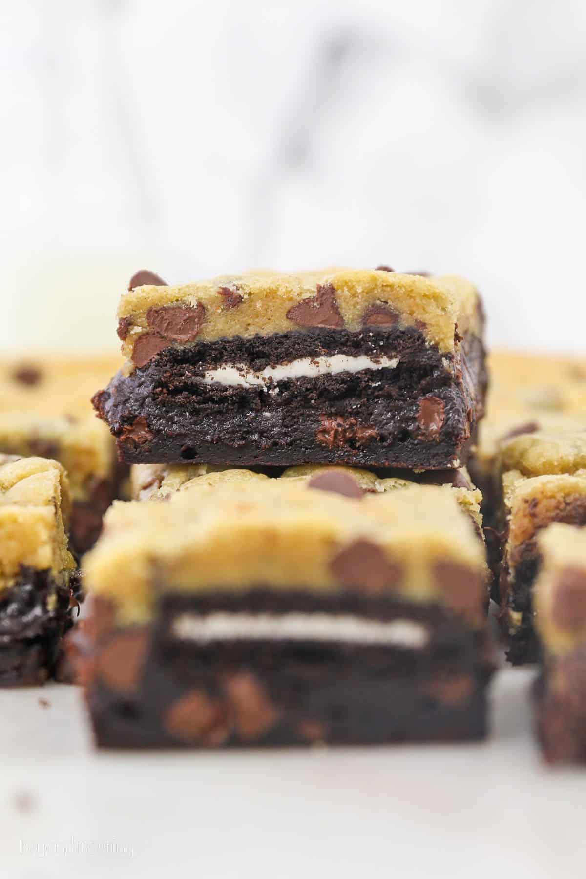 Slutty brownies stacked on a white countertop.
