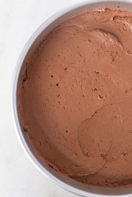 Overhead view of chocolate mousse spread in a cake pan