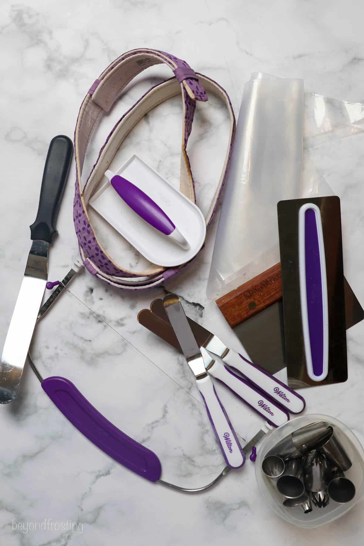 Tools needed to make cakes like icing smoother, bake even stripes and angled spatulas
