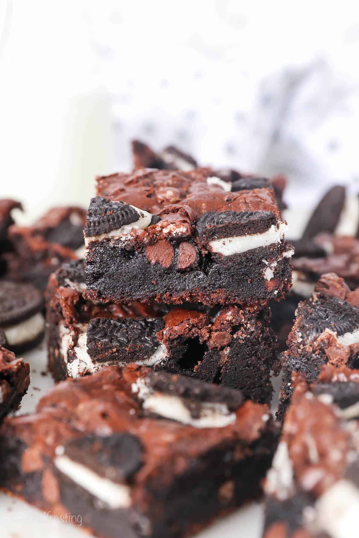 Assorted Oreo brownies stacked on a white countertop.