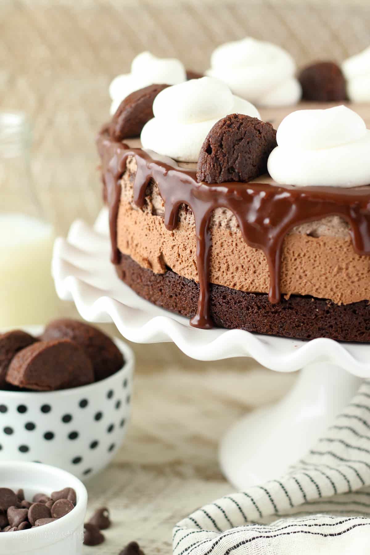 a whole triple chocolate cake on a cake stand.