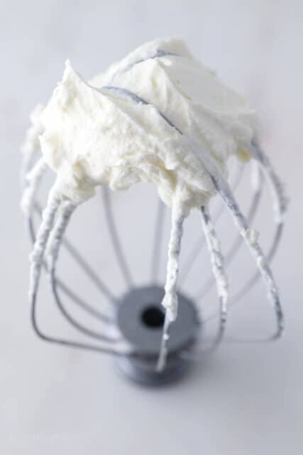 Stand mixer whisk attachment with overbreaten whipped cream