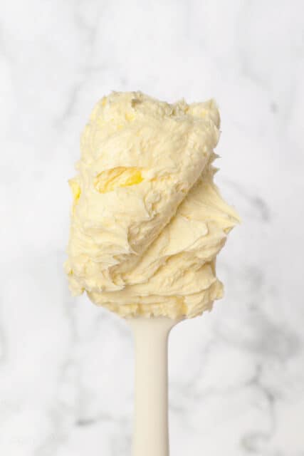 Vanilla buttercream covering the end of a spatula.