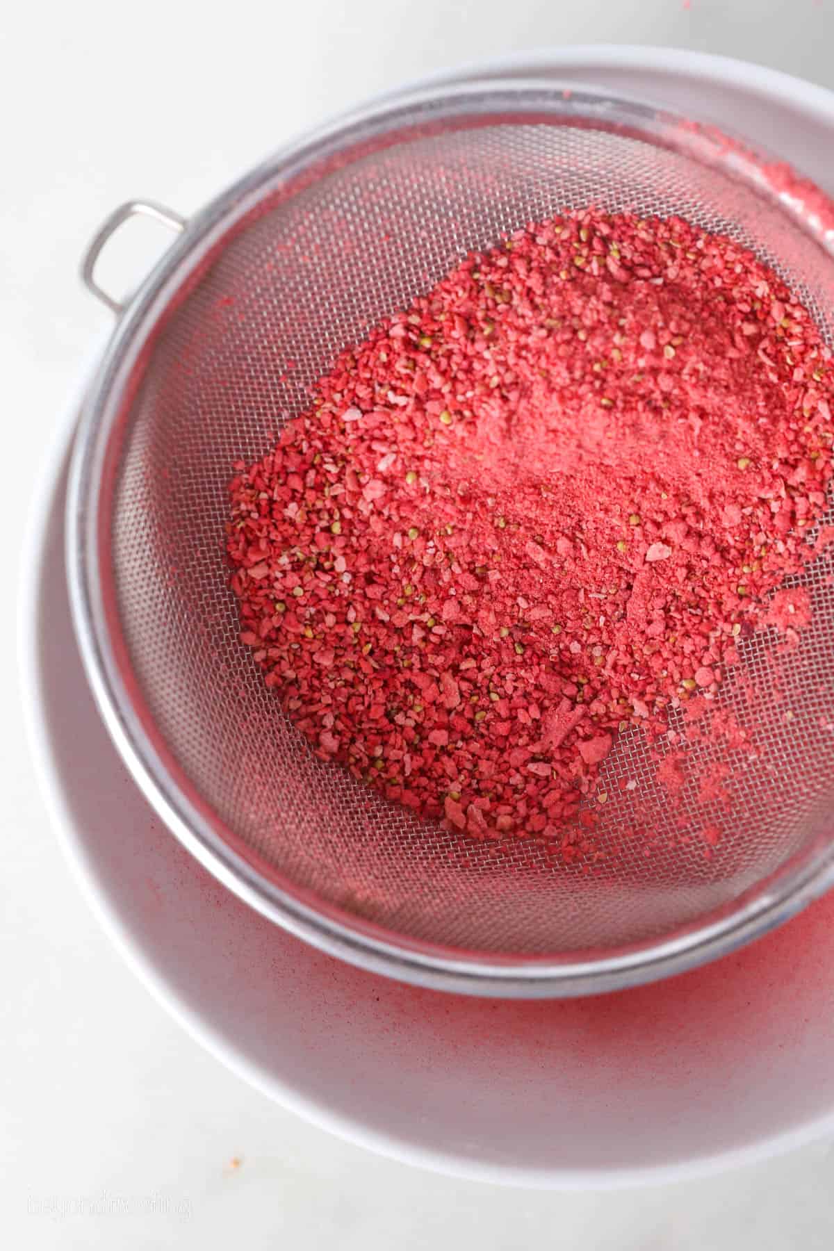 A mesh sieve with powdered freeze-dried strawberries