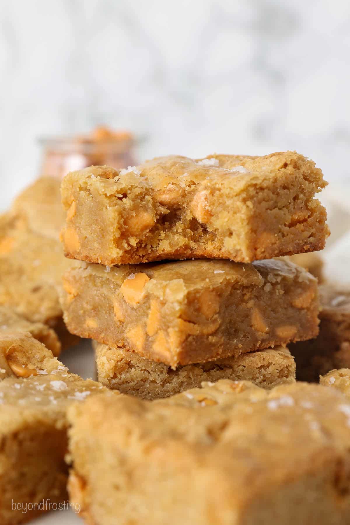 Stacked of Brown Butter Blondies with Butterscotch chips, one is missing a bite