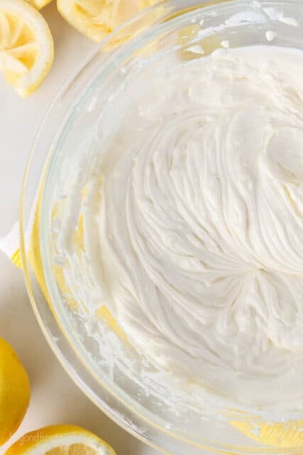 Lemon cheesecake batter coming together in a glass bowl.