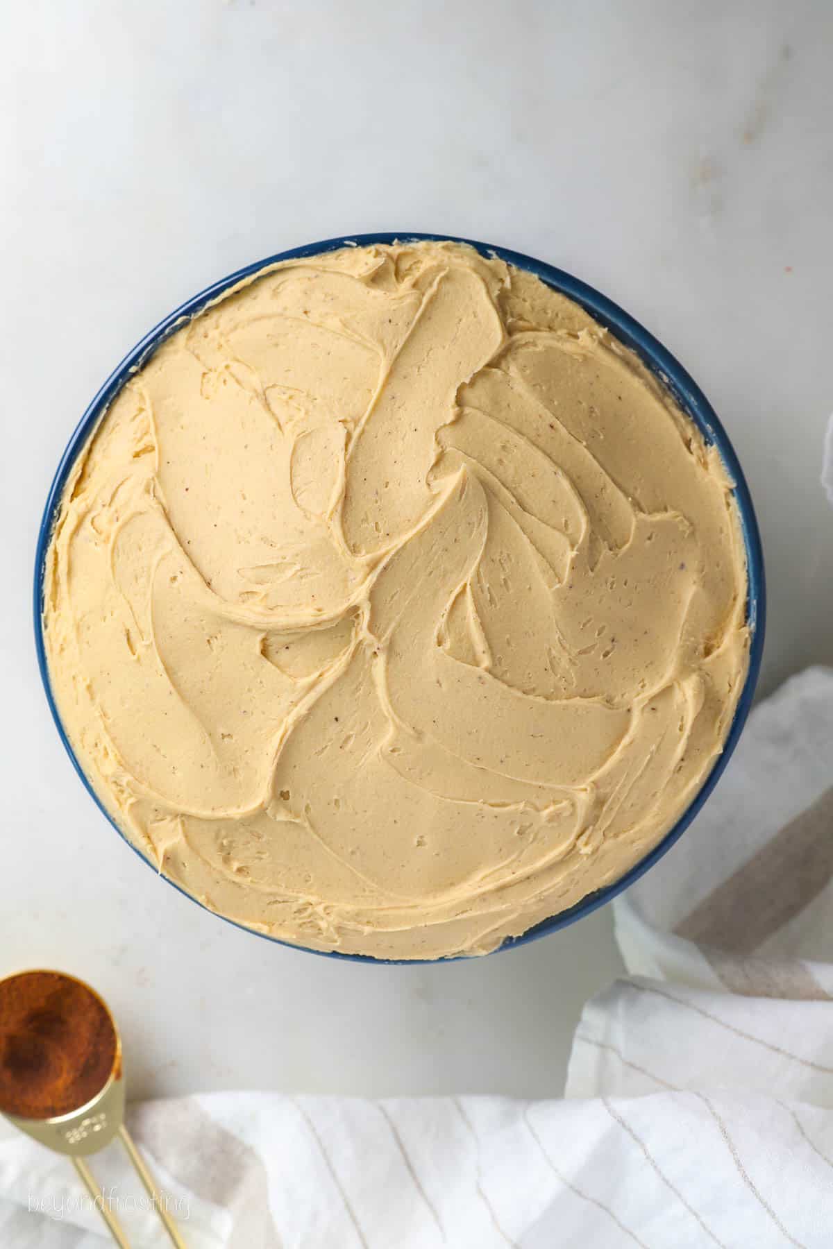 Overhead view of coffee frosting in a large bowl.