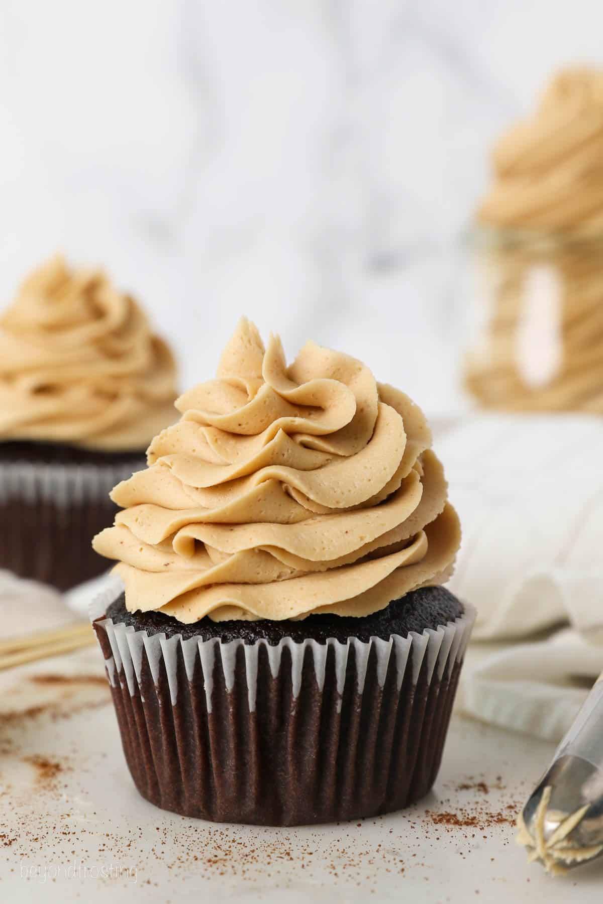 A chocolate cupcake topped with a piped swirl of coffee buttercream.