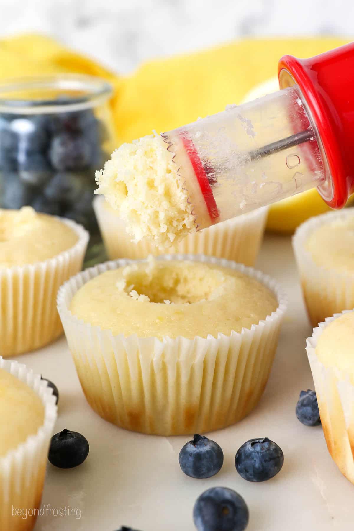 A cupcake corer removing the center of the a cupcake