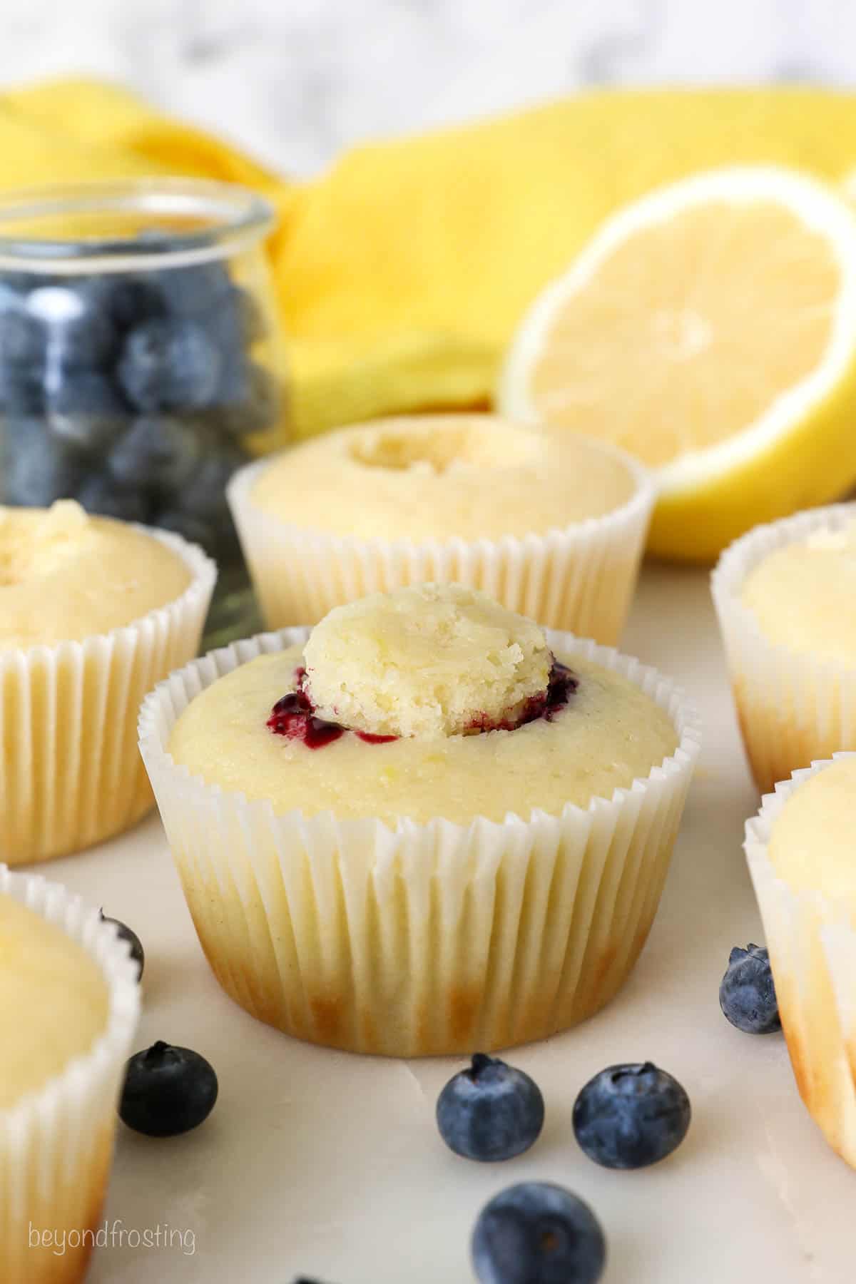A unfrosted lemon cupcake filled with blueberry filling
