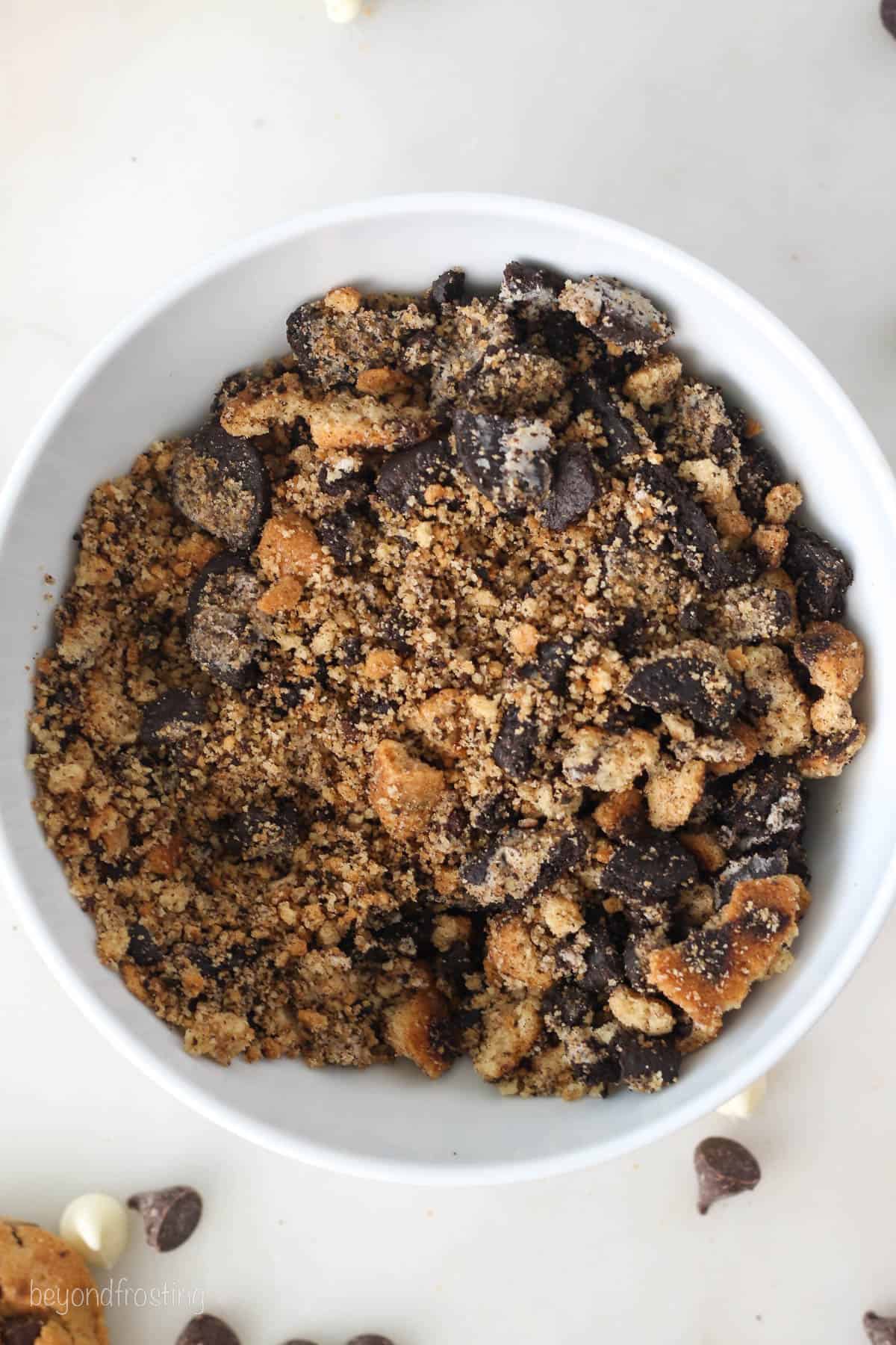 Partially crushed Oreos and Chips Ahoy cookies in a bowl.