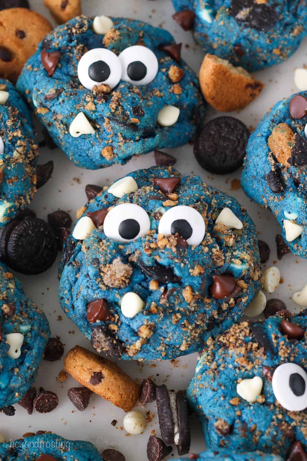Assorted Cookie Monster cookies topped with candy eyes.