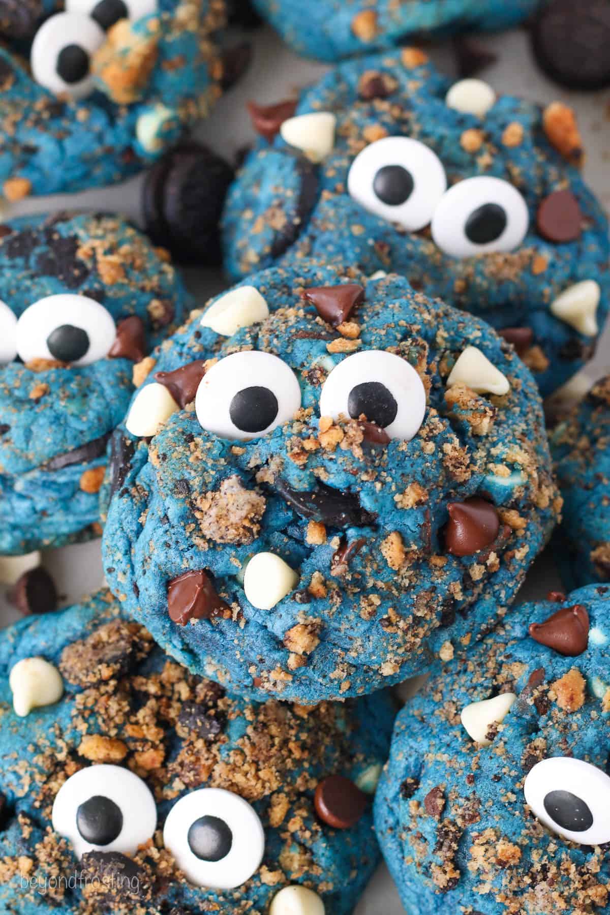 Close up of assorted Cookie Monster cookies topped with candy eyes.