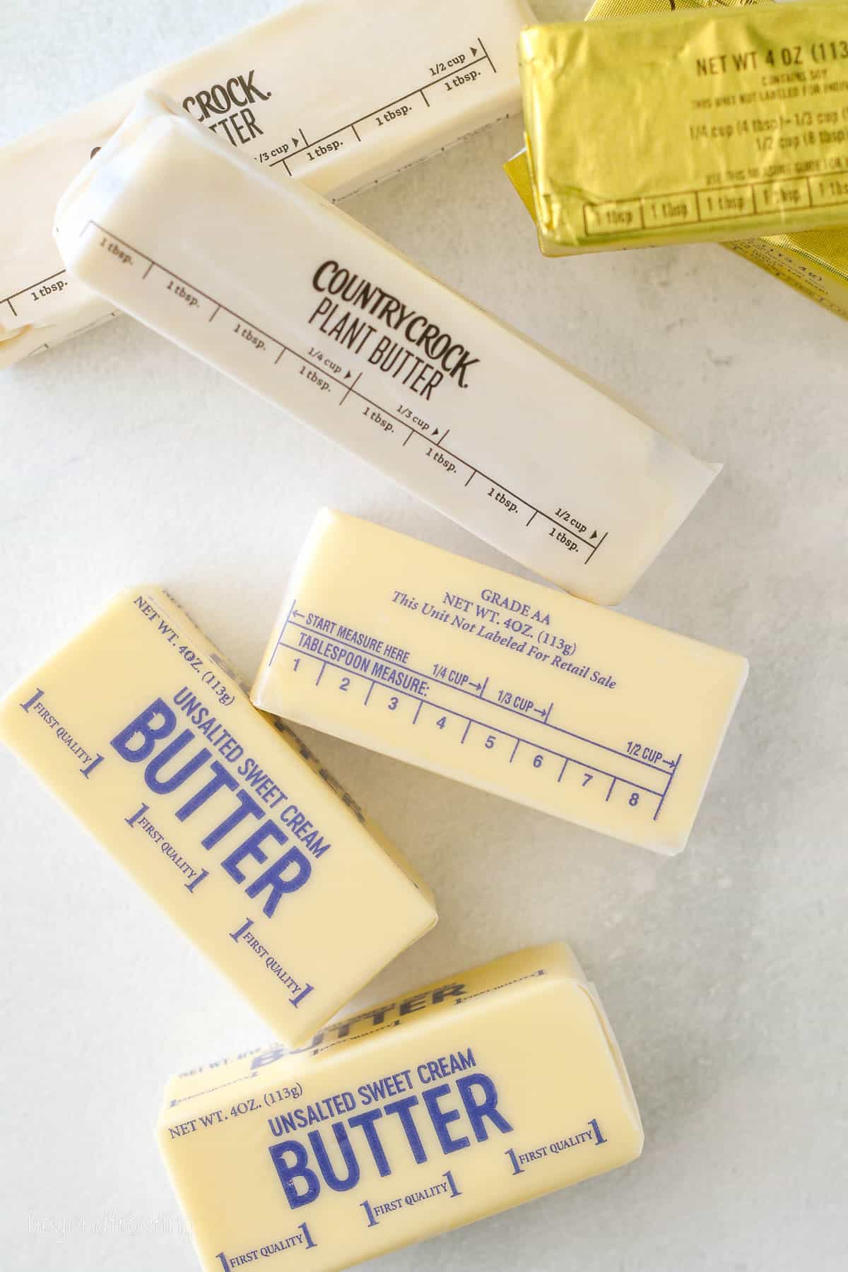 Sticks of butter scattered over a countertop.