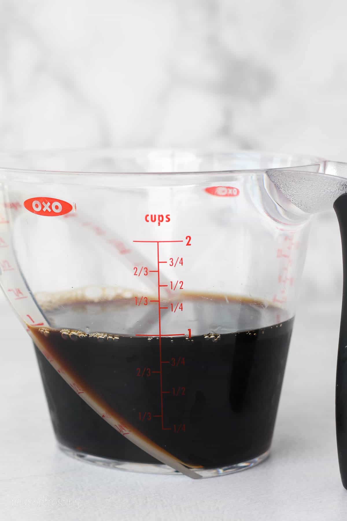 A 2-cup OXO measuring cup filled with 1 cup of coffee