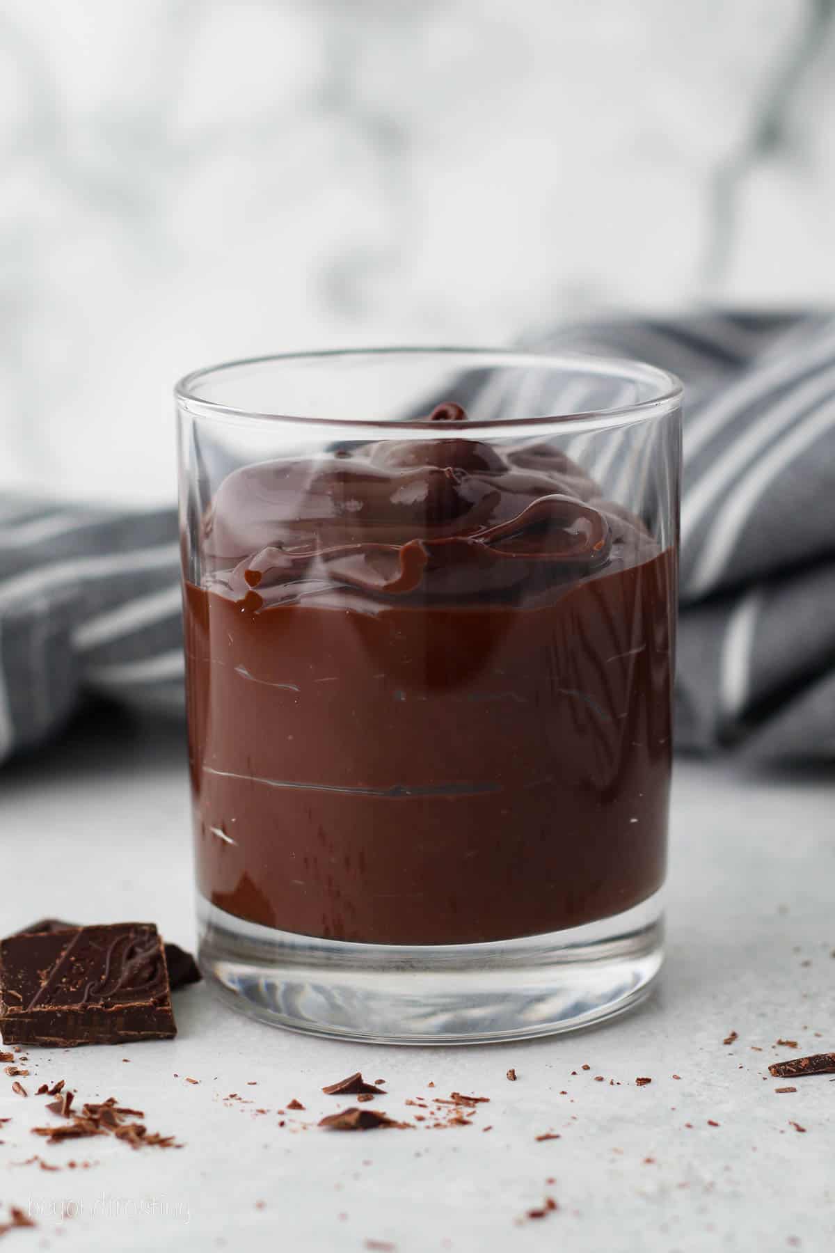 Chocolate ganache in a glass tumbler.