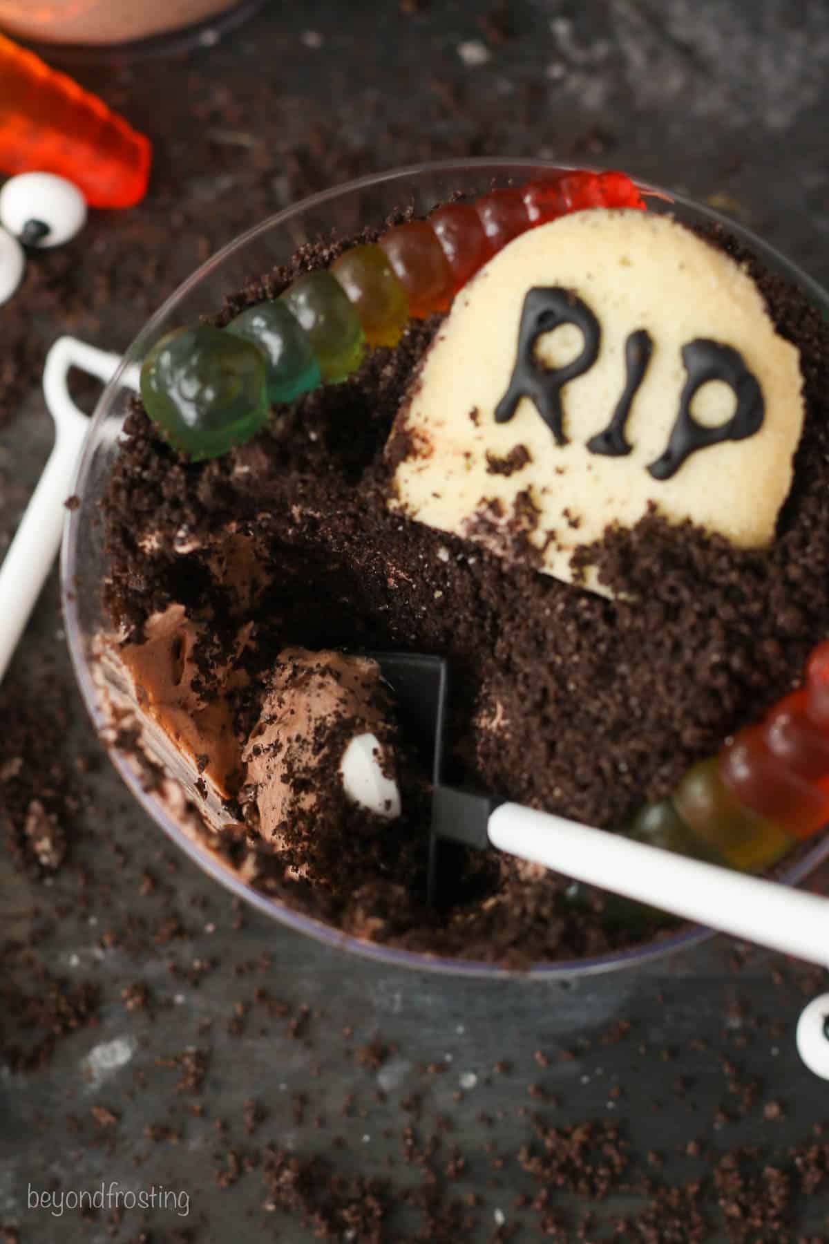 Overhead view of a decorated Halloween dirt cup with a scoop mmissing.