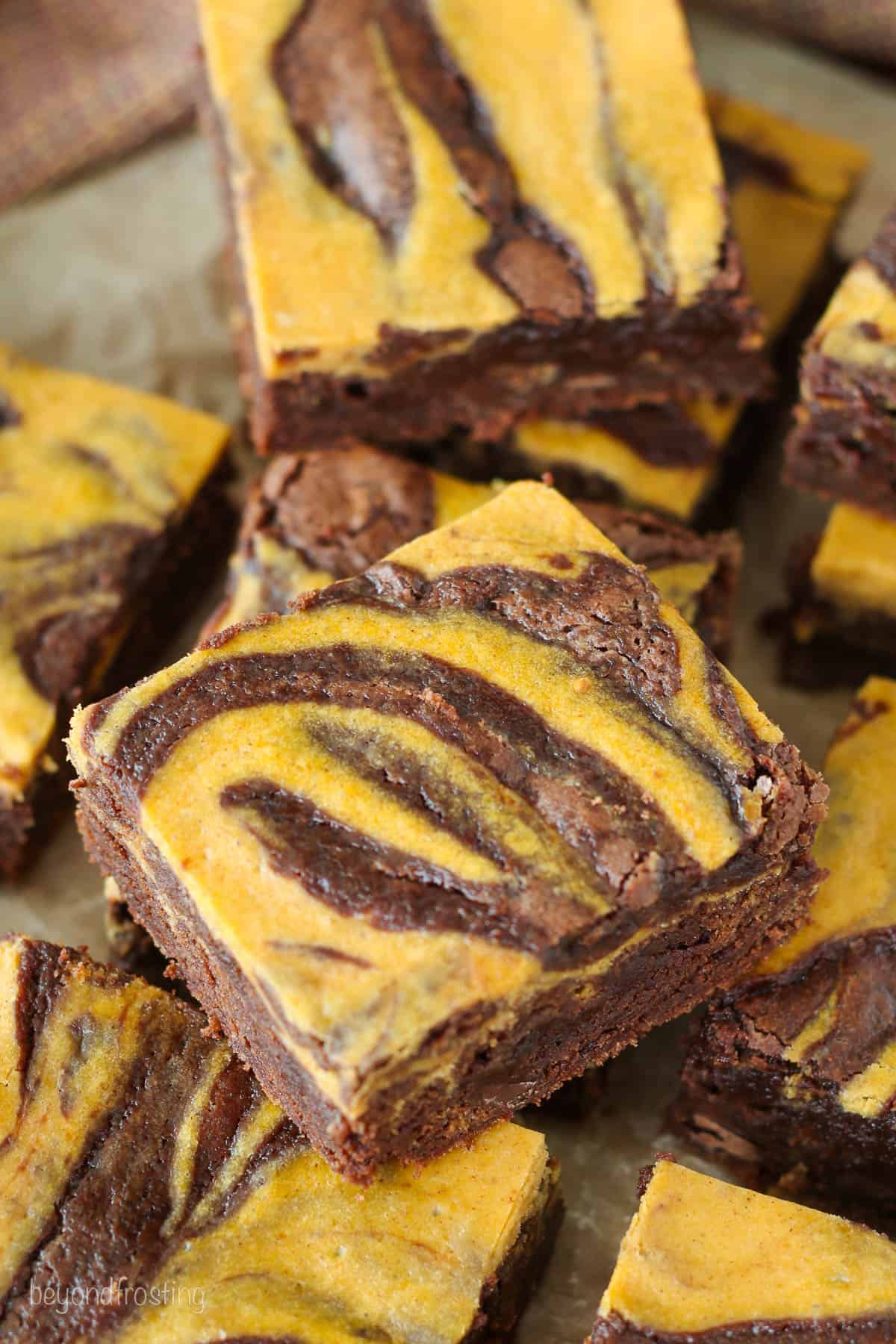 Close up of assorted pumpkin swirl brownies.