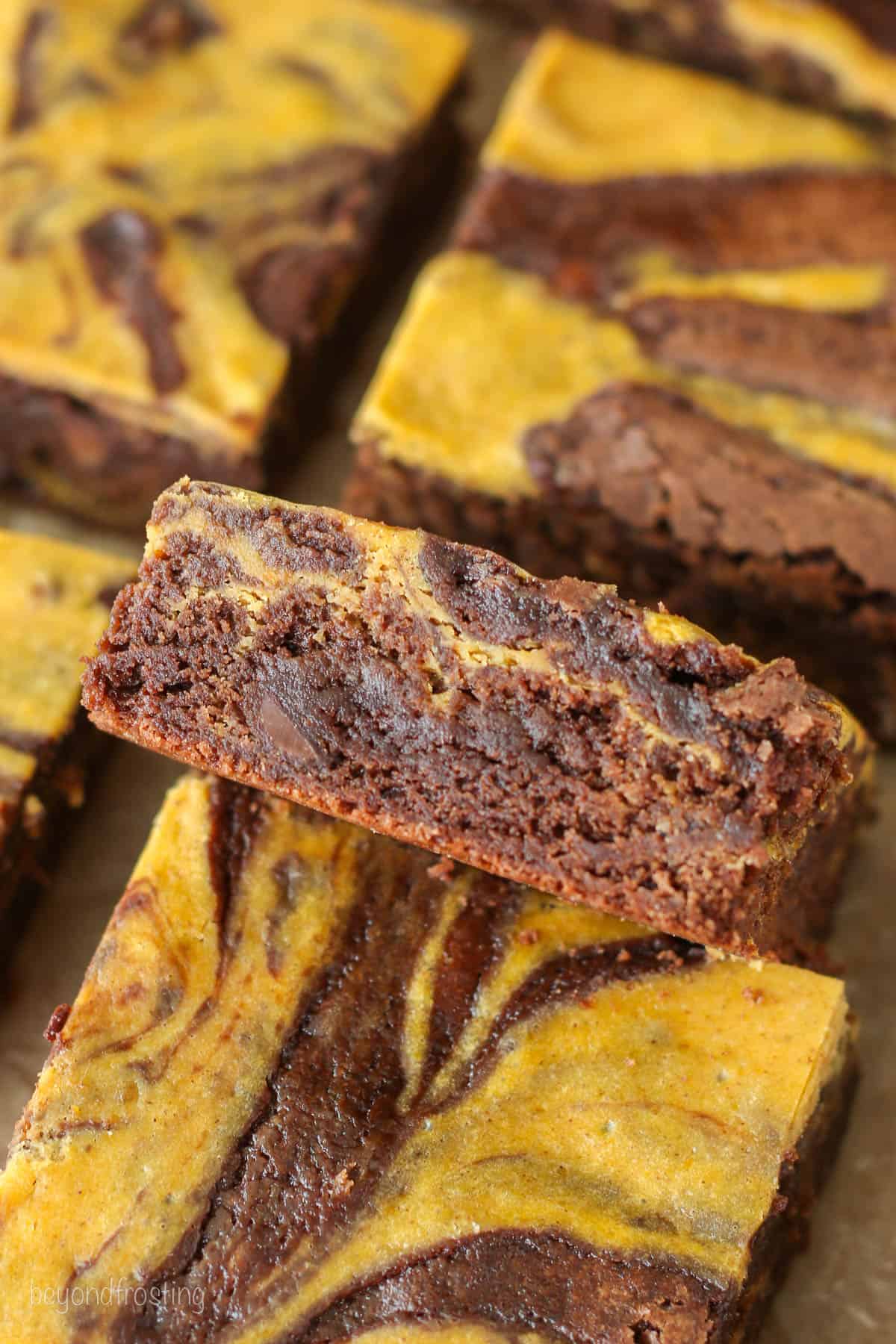 Close up of assorted pumpkin swirl brownies.