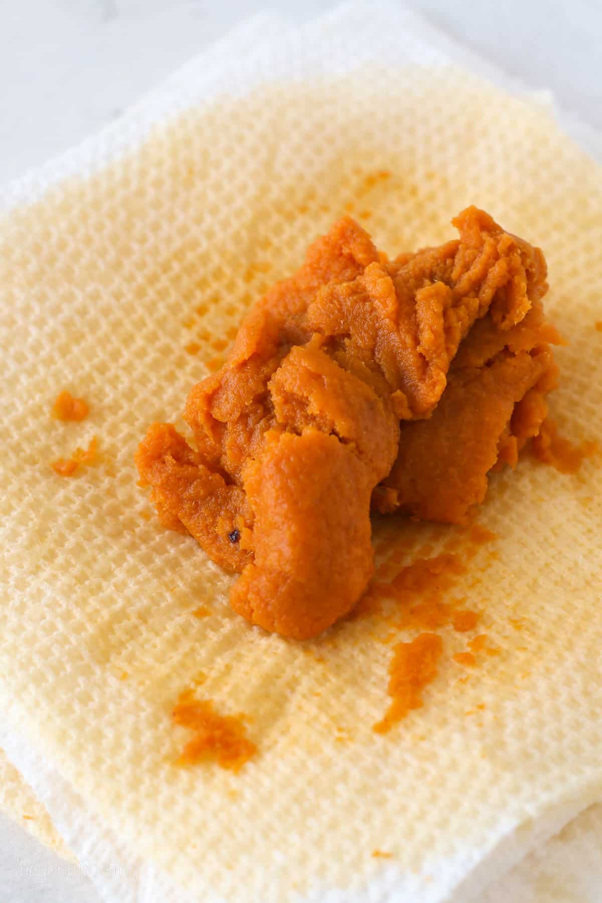 Blotted pumpkin puree on a paper towel.