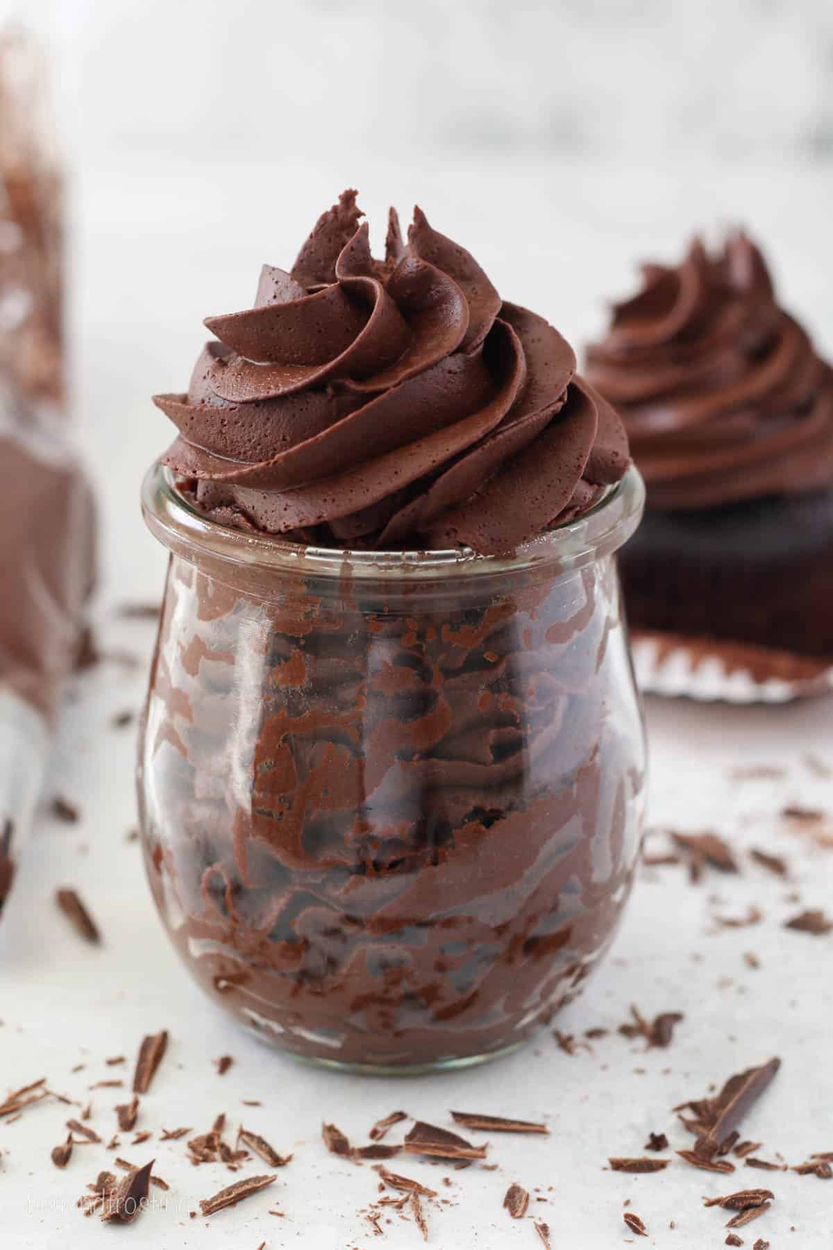 Whipped ganache frosting piped in a glass jar.