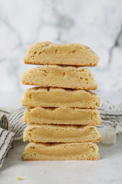 A stack of sugar cookie halves showing the differences in the centers when baked with cream of tartar or a substitute.
