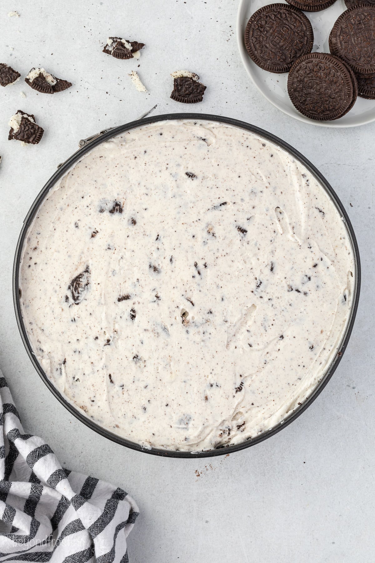 A springform pan filled with oreo cheesecake batter
